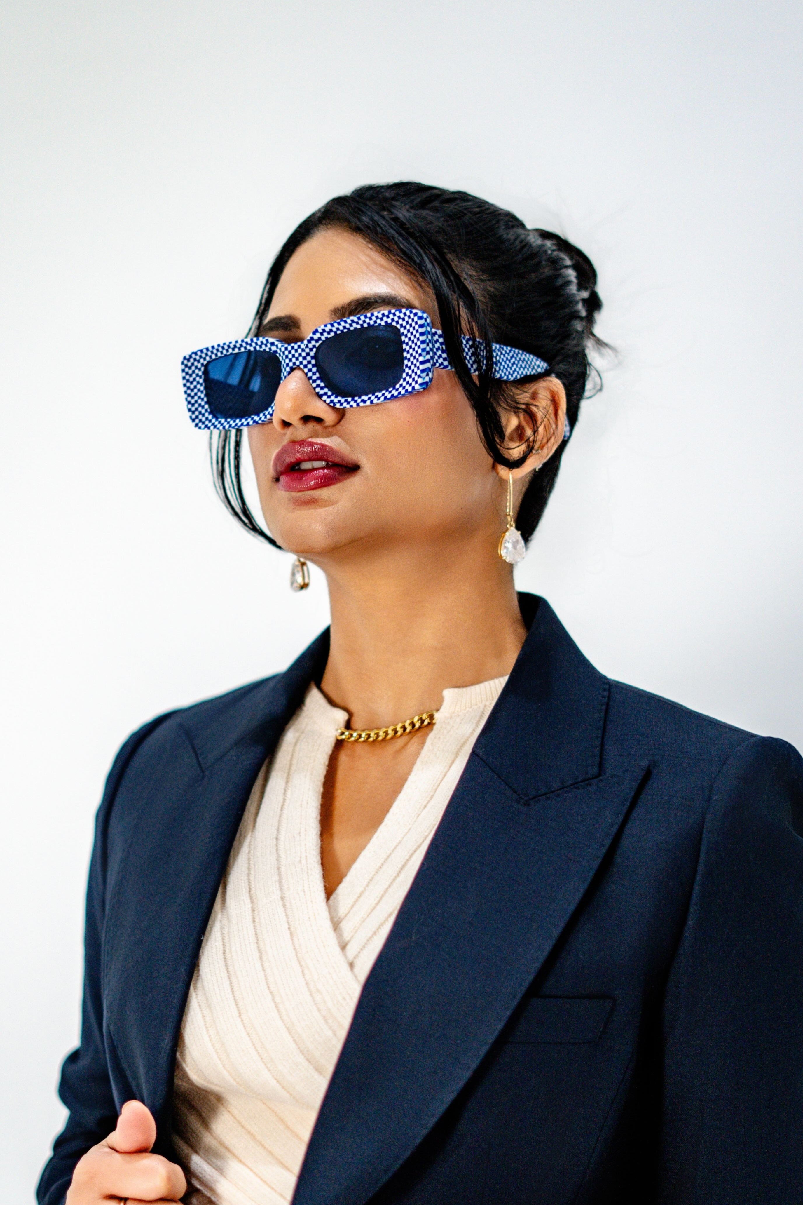 Model wearing Bold acetate sunglasses in blue and white pattern