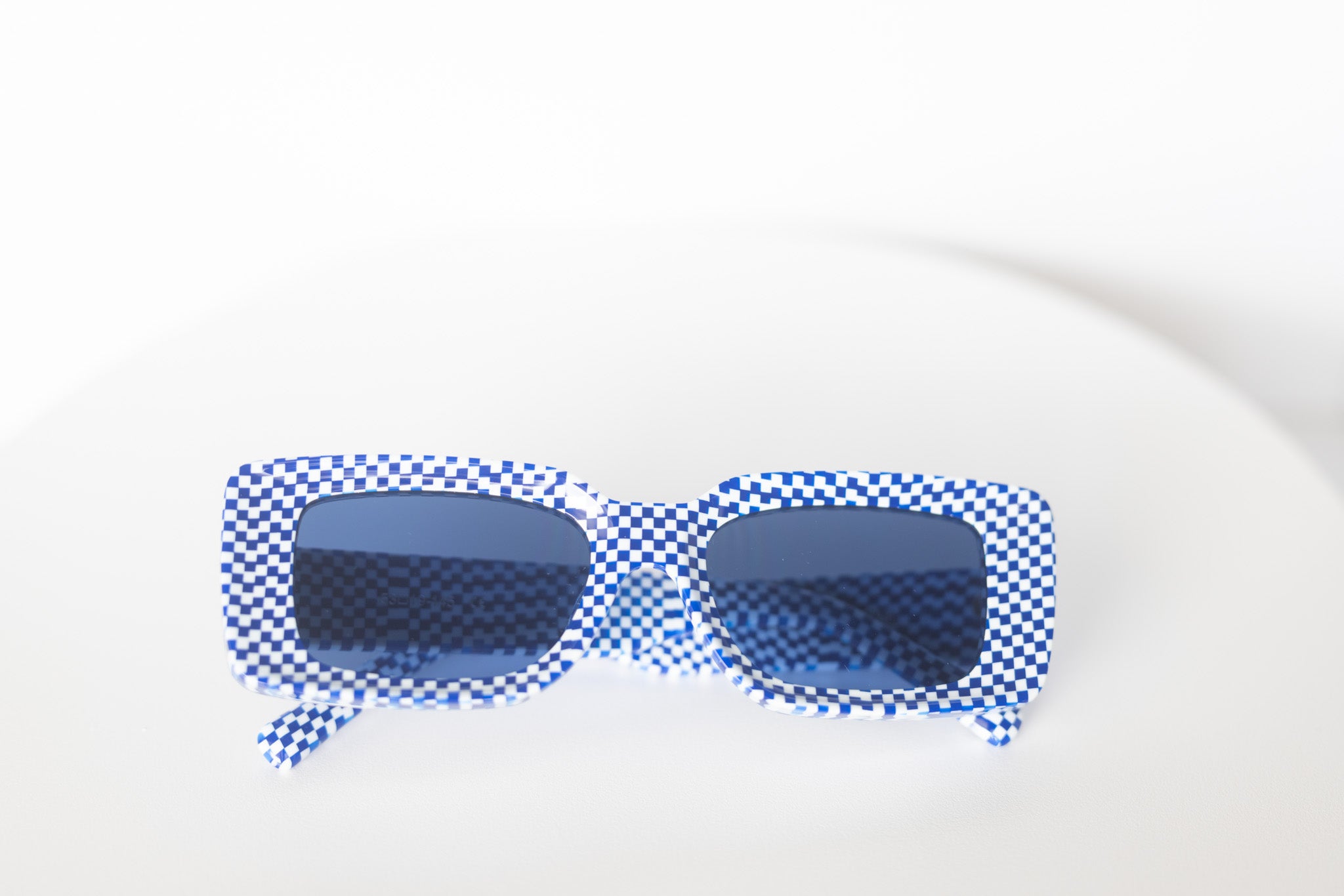 Checkmate Blue sunglasses with blue lenses and sculpted shape