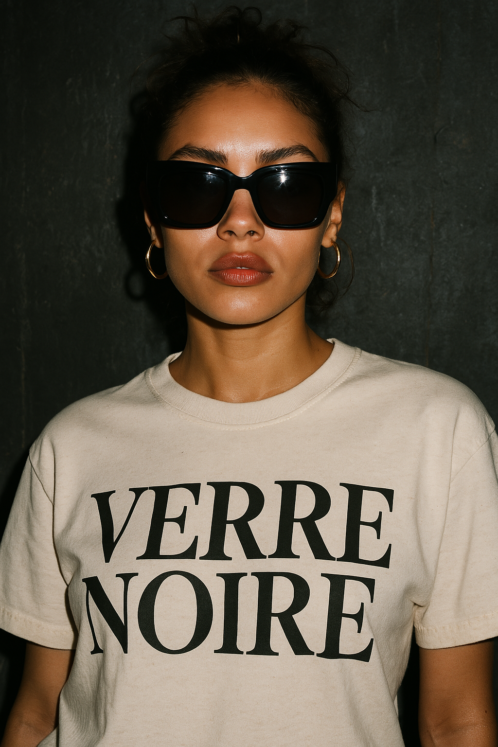 Model wearing Unisex oversized square sunglasses in solid black acetate in a Verre Noire brand shirt